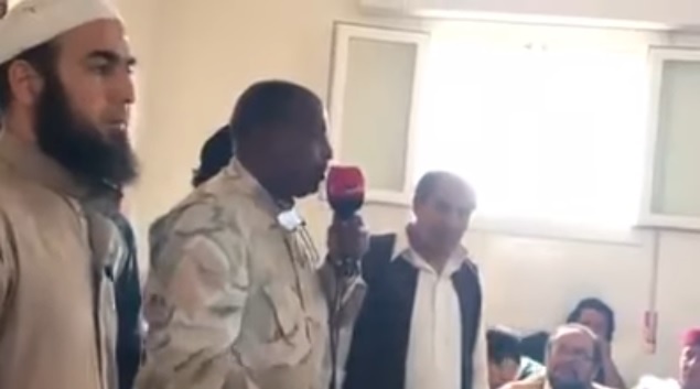 Wanis Bu Khamada addressing a tribal group to give excuses for the shocking videos of crimes 